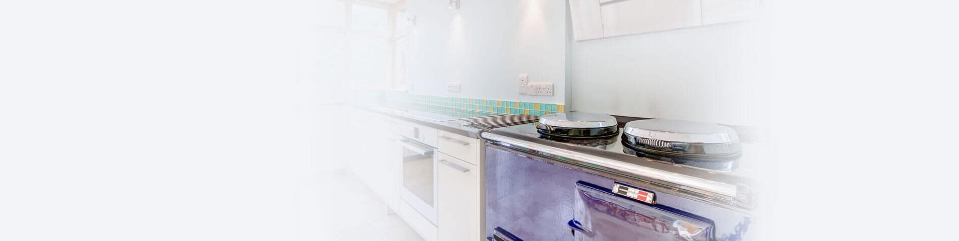 a modern purple two oven Aga range in a light kitchen