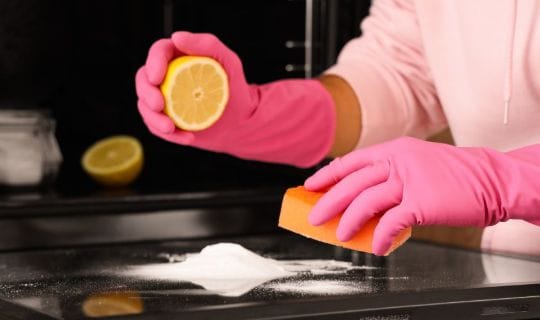 Woman cleaning an oven with natural ingredients